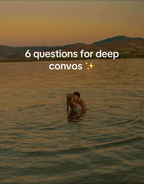 A couple, standing embracing in the water, with a sunset in the background.