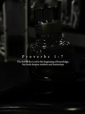 A grayscale, close-up shot featuring a dark, glossy, possibly glass, object with a textured surface. The object is centered and dominates the frame, reflecting light and creating a sense of depth. The background is blurred and out of focus, with hints of indistinct shapes and forms, possibly indicating an indoor setting. Text overlaid includes the verse Proverbs 1:7, with the full verse displayed below. The overall aesthetic is somber and thought-provoking, the dark tones giving it a dramatic feel.
