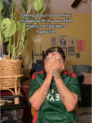 The cover image shows a woman with glasses covering her face with her hands. She's wearing a green shirt. There's a plant to her left, and a room full of framed pictures in the background.