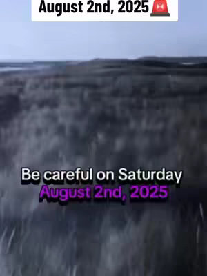 The image shows a blurry, dark landscape scene, possibly a field or open area under a dim sky. Text overlays appear at the top and bottom of the image. The top text reads "August 2nd, 2025" with a red emergency light icon. The bottom text says "Be careful on Saturday" above "August 2nd, 2025" in a different, vibrant purple font, which gives the image a slightly ominous feel.