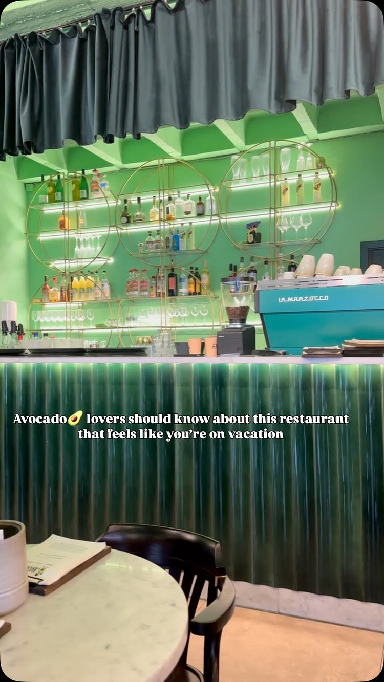 The cover image shows the interior of a modern restaurant or cafe, bathed in green light, a stylish bar with shelves of drinks and glasses, and a partially visible table and chair set in front. The image also contains text overlaid.