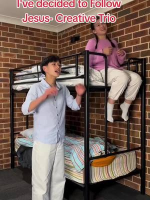 A scene inside a room with brick walls. Two young people are on a bunk bed. One person is standing up and gesturing with their hands, while the other is sitting on the upper bunk. Text is overlaid at the top indicating the video's message and branding.
