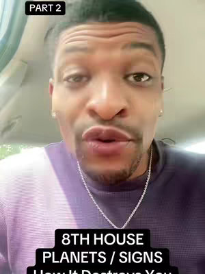 A close-up shot of a Black man with a shaved head, wearing a purple and white striped shirt and a silver chain. He is in a car, looking directly at the camera with a serious expression. The background is blurred, suggesting the interior of a vehicle. Text overlays at the top and bottom of the image.
