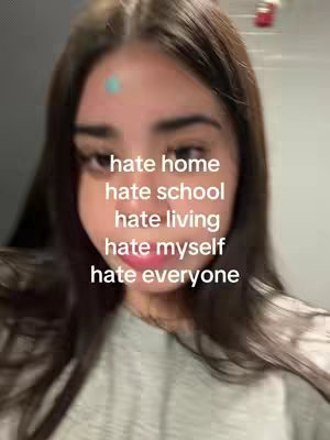 A young woman is centered in the shot, her face filling most of the frame. Text overlays expressing negative emotions are stacked vertically over her.