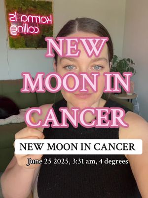 The cover image is a selfie-style shot featuring a woman centered in the frame. The upper portion of the image has text overlayed in a pink, slightly transparent bubble font. The text, partially obscuring the subject, reads 'NEW MOON IN CANCER'. Below, there's additional text within a white rectangle, detailing the date and time of the new moon. A light green surface is in the background, with a framed wall decoration on the upper left.