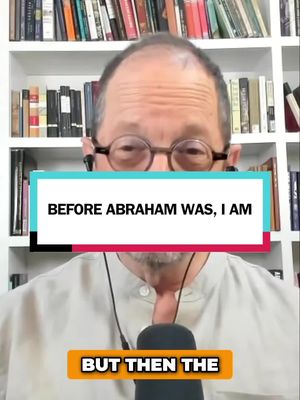 A man with glasses is centered in the frame. Above him is a bookshelf with a variety of books in the background. A text overlay with a white background and black text is prominent across his chest. Below this, a smaller text overlay is visible at the bottom.