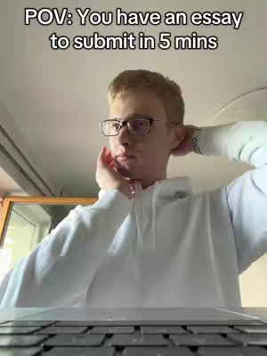 A young man sitting in front of a laptop with a surprised expression. The image is taken from a POV angle, conveying a sense of urgency.