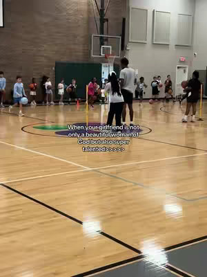 The cover image shows a basketball court inside a gymnasium. A group of people, including adults and children, are present, some holding basketballs. Text overlayed in the center reads: "When your girlfriend is not only a beautiful woman of God but also super talented".