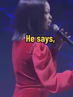 The cover image shows a woman singing into a microphone on a stage. She is wearing a red dress and has short, dark hair. The background is dark, with blue and purple lighting. Text overlayed on the image says "He says,", in a yellow font, inside a black box.