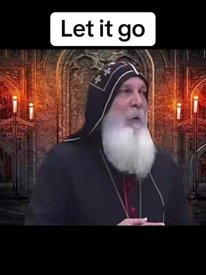 A man with a white beard and a black robe stands in front of a church-like background with candles.