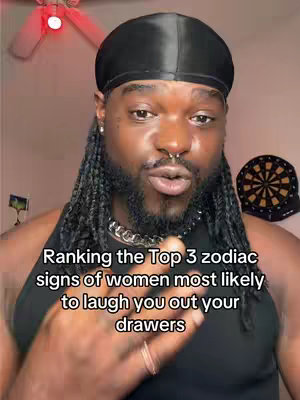 A close-up shot features a Black man with a black durag, braids with beads, and a nose ring. He's looking directly at the camera, his face in focus. The background hints at a home setting, with a dartboard visible. Overlay text at the bottom names the content.