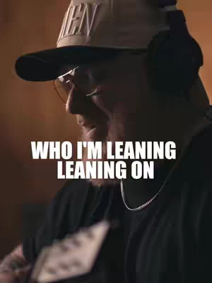The cover image features a man wearing a hat and headphones, partially visible in profile. The man is singing, with text overlayed which creates a warm, inviting environment.