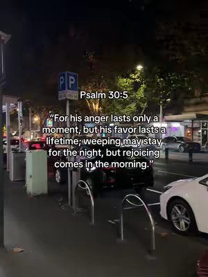 The image shows a nighttime street scene with parked cars, buildings, and streetlights. Overlayed is a bible verse from Psalm 30:5.
