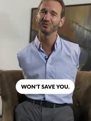 A man in a light blue button-down shirt is seated on a brown couch. A white oval-shaped text box is positioned at the bottom of the frame.