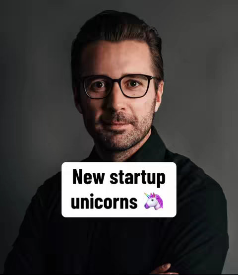 A man with glasses in a black shirt against a gray background, with a white box overlay containing text and a unicorn emoji.
