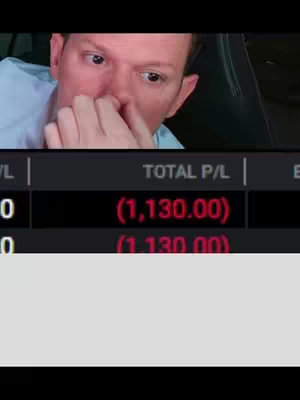 A man with a look of concern or surprise is shown in the upper portion of the frame. Below him, a screen displays financial figures with negative numbers in red.