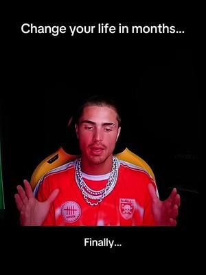 A man in a red soccer jersey and jewelry gestures towards the viewer against a dark background with overlayed text. Text at the top reads \"Change your life in months...\" and the word \"Finally...\" is printed at the bottom of the image