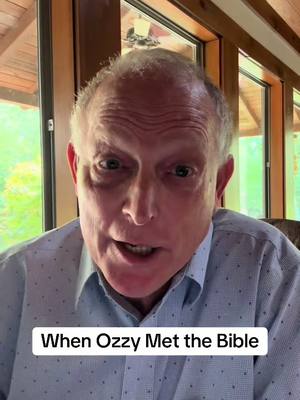A medium shot features an older man with gray hair, looking directly at the camera and speaking. The man has a light blue button-down shirt. Below him a white band with black text 'When Ozzy Met the Bible'. The background includes indoor window with trees. The overall lighting is bright and natural.