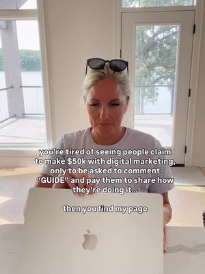 A woman with blonde hair wearing sunglasses on top of her head is sitting in front of an open laptop. Text overlays are present. She is in a well-lit room with large windows and a view of a landscape.
