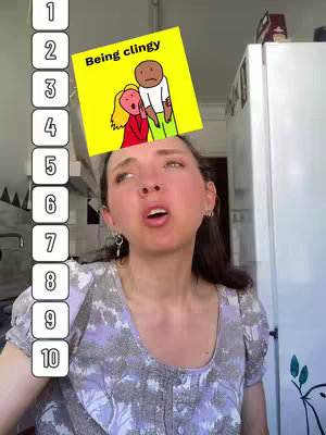 A woman with brown hair and a floral top looks upwards with an open mouth and widened eyes. The number 1 to 10 runs in a vertical list on the left side. A square yellow sticker, with a cartoon illustration of a couple stands above her head, and the words "Being clingy" are inside.