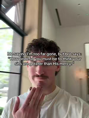 A man with short brown hair and a mustache stands indoors, his right hand raised towards his face. Text overlayed on the image contains a quote with a religious theme.