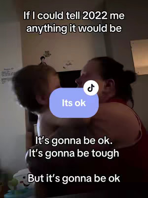 A woman is embracing a child. Text overlays on the clip; the woman is in profile, and the child's face is partially visible.