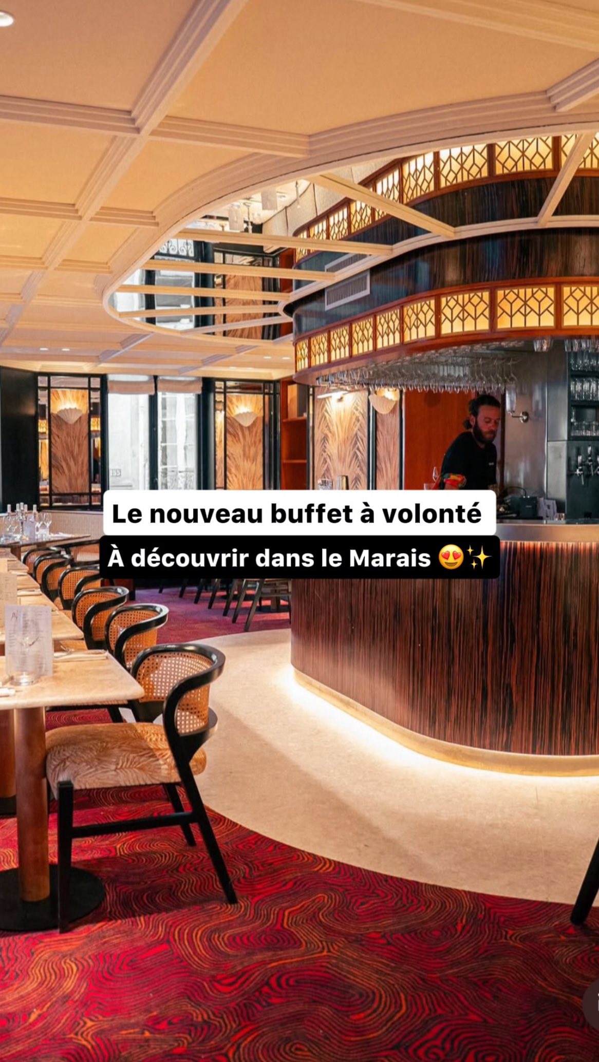 The cover image shows the interior of a modern restaurant with a focus on a buffet area. The warm lighting and wooden accents suggest an inviting atmosphere. The text overlay suggests promoting a new all-you-can-eat buffet in the Marais district.