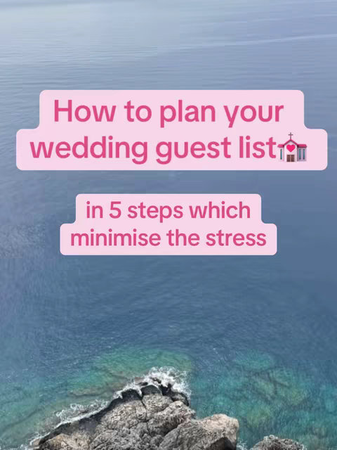 The image is a vertical shot showcasing a bright pink text overlay on a backdrop of the ocean and a rocky shoreline. The text is arranged in two pink rectangular boxes and reads 'How to plan your wedding guest list' followed by a second box stating 'in 5 steps which minimise the stress'. A small illustration of a heart and a church appears at the end of the first text box. The background features varying shades of blue indicating open water with a rocky outcrop in the foreground.