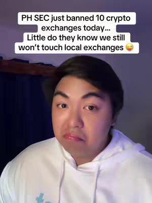 A selfie-style video cover image featuring an Asian man in a white hoodie. Text overlays the man with a statement about the Philippines SEC banning crypto exchanges. His facial expression suggests a mix of surprise and sarcasm. The background appears to be an interior setting with muted colors.