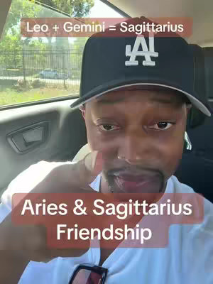 A selfie taken from inside a car. The focus is on a man in a black baseball cap with the LA logo. He is smiling and pointing towards the camera. There is text overlay at the top and bottom.