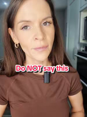 A woman with long brown hair is centered in the frame, looking towards the camera. She wears a brown t-shirt and a small black microphone is clipped to it. A text overlay reads, "Do NOT say this" in a white rounded font, set against a pink background. The background is a blurred view of what appears to be a kitchen.
