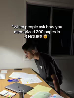 A young man leans over a desk studying. The scene is under a muted lighting condition. Text overlayed on the upper mid-portion of the image quotes, "when people ask how you memorized 200 pages in 3 HOURS..." with an emoji. Papers, notebooks, a laptop, and various study items are scattered across the desk, creating a study atmosphere.