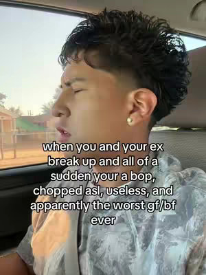 The cover image is a selfie taken from inside a car. The main subject is a young man with short, textured hair, a clear complexion, and a stud earring. His expression is a mix of seriousness and slight distress, with his eyes closed or squinting. The background reveals an out-of-focus street scene. Overlayed text is visible at the bottom, written in a clean white font, providing context to the image.