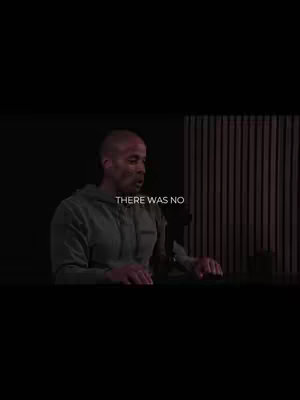 The cover image shows a man, likely David Goggins, speaking in front of what appears to be a stage or a recording studio. He wears a grey hoodie and is actively gesturing with his hands, suggesting he is in the midst of a presentation or a heartfelt expression. The background fades to black, drawing complete attention to the main subject.