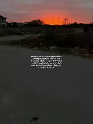 The image shows a road leading away from the viewer, with a dark, blurry foreground and a sky filled with vibrant orange and pink hues. A sentence is overlaid on the image, centered near the bottom. The overall tone is somber and reflective.