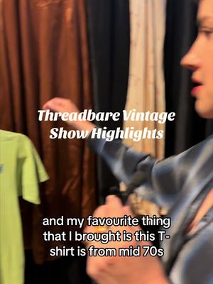 A woman in a vintage shop is holding a vintage green T-shirt with a print. Overlaid text announces the items are from the 'Threadbare Vintage Show'.