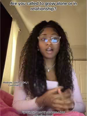 A young woman with long dark curly hair and glasses is centered in the frame, looking directly at the camera. She's wearing a light-colored top and a cross necklace. Text overlays provide context: "Are you called to grow alone or in relationship?" at the top, scripture references in the lower left, and a note about 2x speed at the bottom.