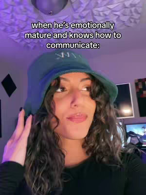 A young woman with curly brown hair wearing a green bucket hat and a black shirt looks up toward the left side of the frame. Text overlay is white and positioned across the top of the image.