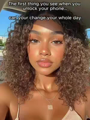 A selfie featuring a woman with curly brown hair, fair skin, and soft lighting. The text overlay is in the upper portion of the image. She is wearing a delicate gold necklace and what appears to be a beige top. The background is partially visible, suggesting an outdoor setting, possibly in a car.