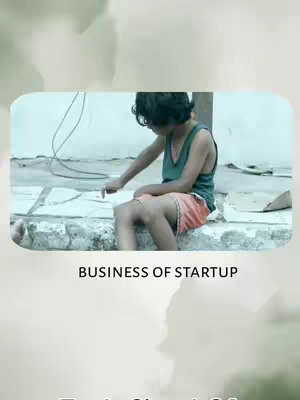 The cover image features a young person sitting with their legs crossed, focused on something they are pointing to on a surface. The person wears a green tank top and orange shorts. The background has a neutral wall, the person sits on a stone slab. The overall composition is simple, with the central focus on the person and the text overlay at the bottom.