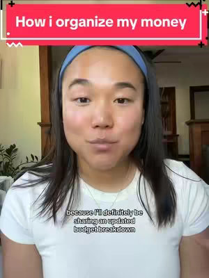 A woman with black hair and a blue headband is centered in a shot, looking at the viewer. Above her is a red bar with white text and a black border at the top. Below the image is text that says "because I'll definitely be sharing an updated budget breakdown". The background is a blurred indoor setting with wooden elements.