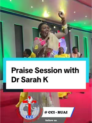 The image features a woman with dark skin in a lively church setting. She is the main focus, holding a microphone and singing passionately with her arm raised. Behind her, other people are visible singing, and a logo with the church's name is at the bottom. The setup includes stage lighting and a well-lit backdrop, suggesting the performance is underway.