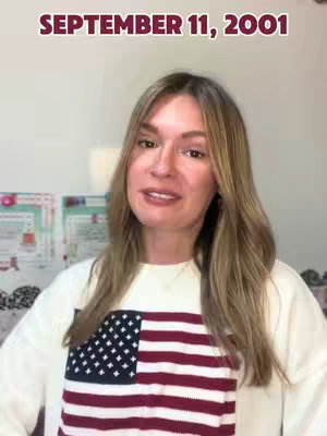 A woman with long blonde hair is smiling and looking at the camera. She is wearing a white sweater with an American flag design across the chest. Above her head, the text "SEPTEMBER 11, 2001" is displayed in a maroon font.