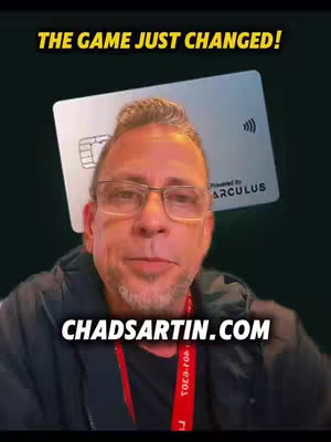 A man wearing glasses is centered in the image, with a credit card hovering above him. Text overlays include the title and a website address. The background has a dark gradient. The man is wearing a black jacket and the setting appears to be indoors.