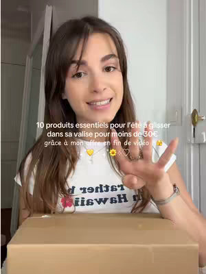 A young woman with long brown hair smiles and gestures with her hand. She's wearing a white t-shirt, and a brown cardboard box is in the foreground. Text overlayed on the image announces the video's focus.