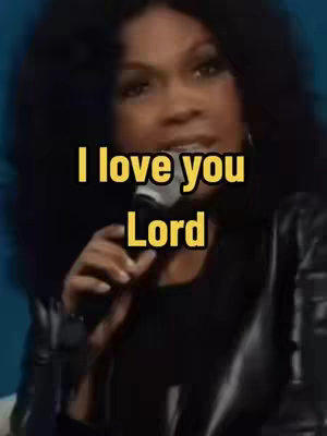 The cover image features a close-up of a woman holding a microphone and singing, with a yellow text overlay that reads 'I love you Lord'. The woman has dark hair and is wearing a dark-colored outfit. The background appears to be a dimly lit setting.