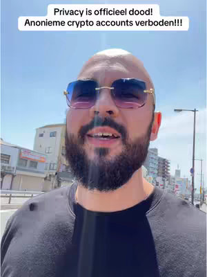 A man wearing sunglasses stands outdoors, looking towards the camera. Above him, text is overlaid onto the image against a pale blue sky. Buildings are visible in the background.