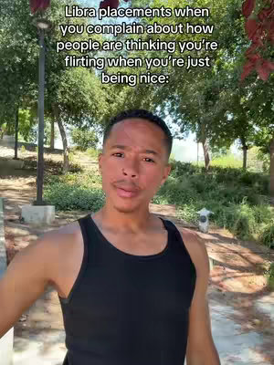 A man in a black tank top stands outdoors with trees and a streetlamp in the background. Text over the image reads, "Libra placements when you complain about how people are thinking you're flirting when you're just being nice:"