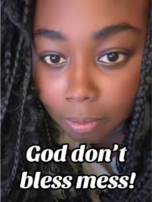 A close-up shot shows the face of a person with dark skin. The person has their eyes open, looking at the camera, with dark eyebrows. The person's hair is styled in braids. Superimposed on the image is the white text: 'God don't bless mess!'