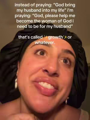 A close-up shot of a woman wearing a black headscarf, looking up with a slightly playful or questioning expression. She has fair skin, visible eyebrows, and hints of eyeshadow. The background is blurred, highlighting her face and the overlaid text.